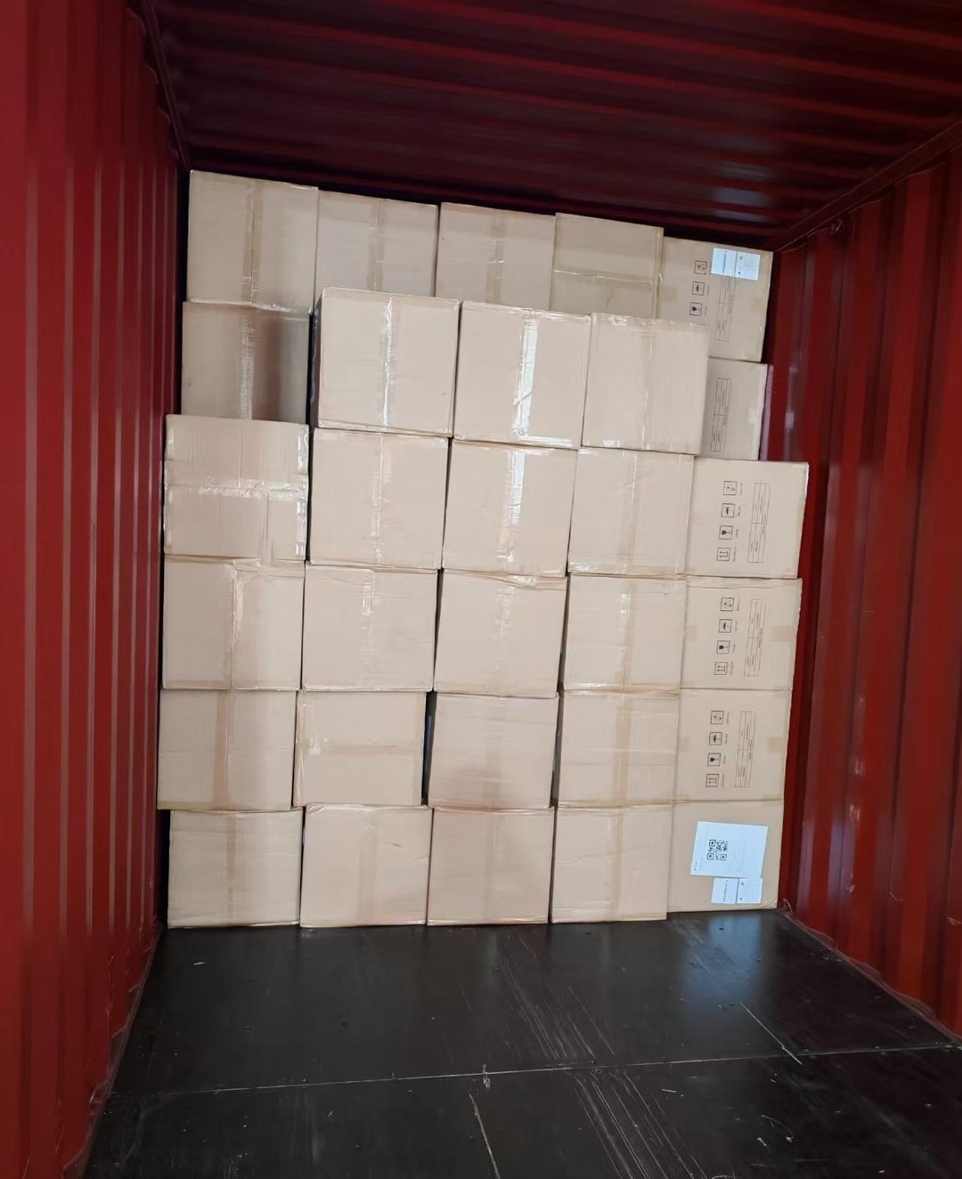 Interior view of a 40HQ container fully loaded with fan cartons, floor-loaded without pallets